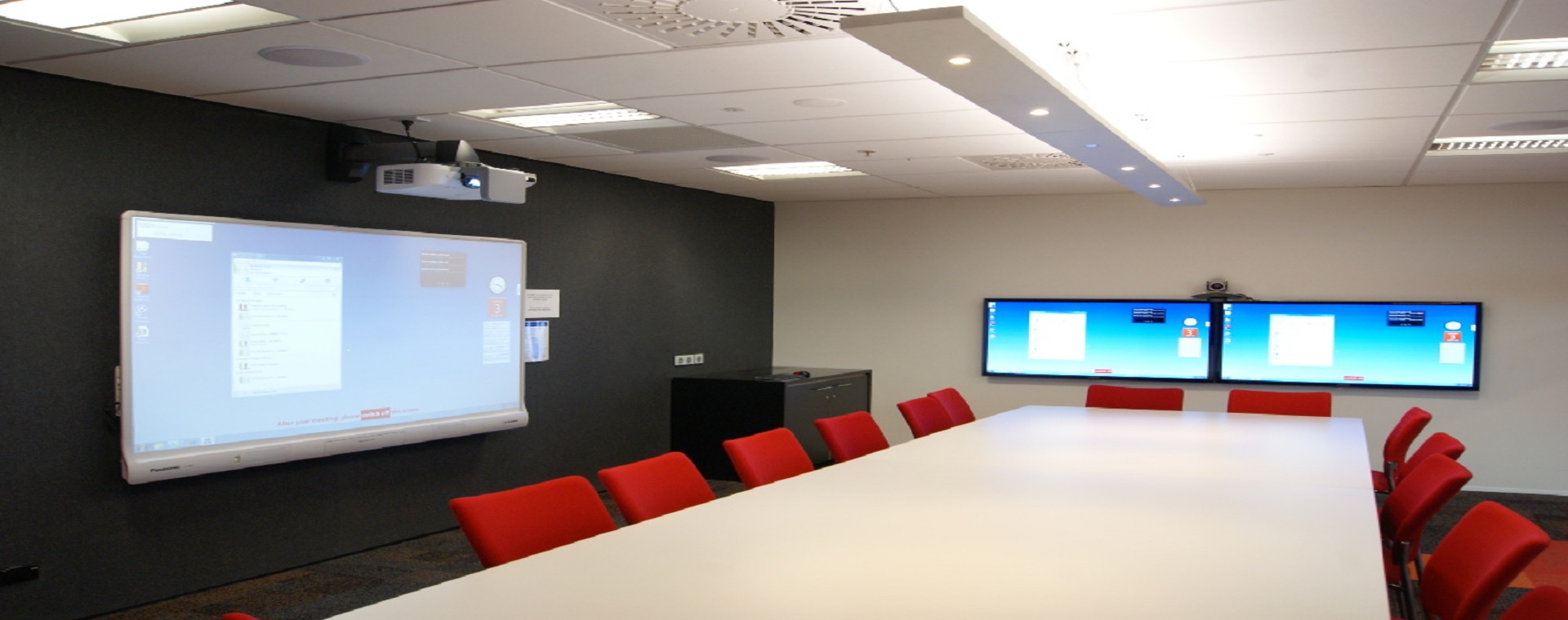 BECA meeting room with short-throw projector and 2 large format display panels
