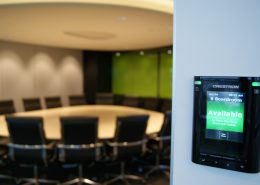 Available sign on black Wall mounted Crestron boardroom booking system