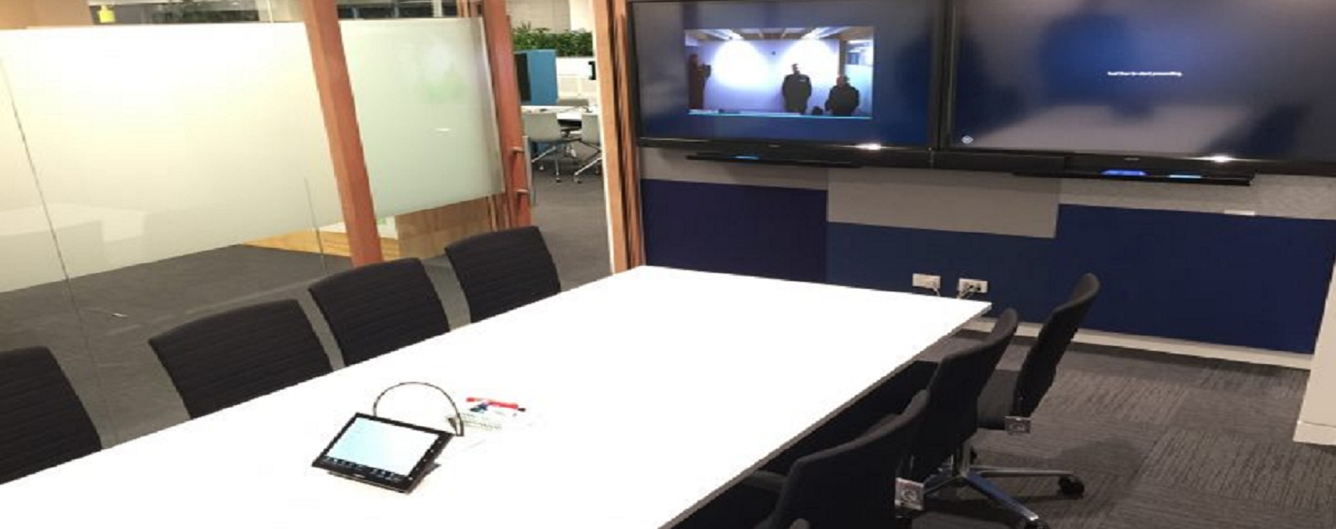 Meeting room at Fonterra Experience Centre with device connectivity, touchscreen control and 2 large format display screens