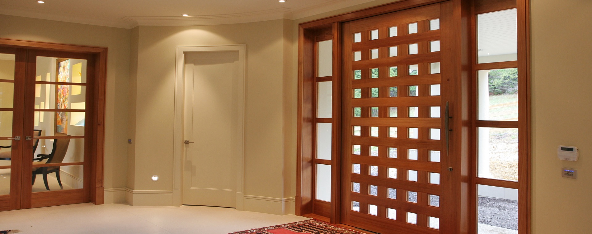 Large entry to a modern home with home automation in-wall touchscreen