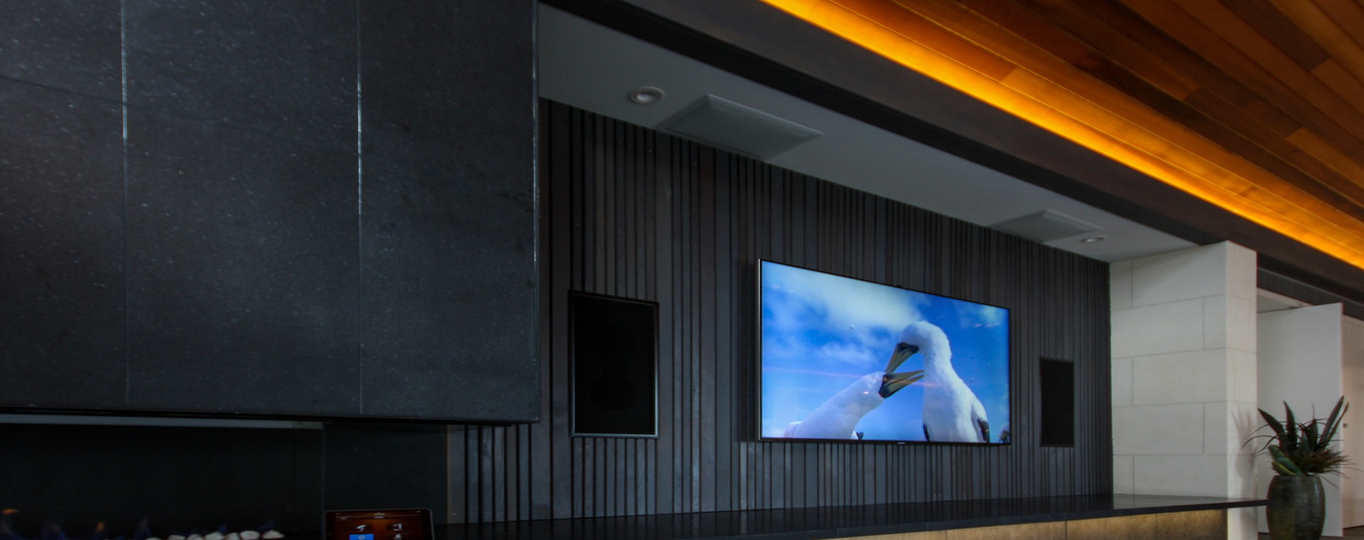 Home theatre with in-wall speakers and LED lighting, controlled by home auotmation