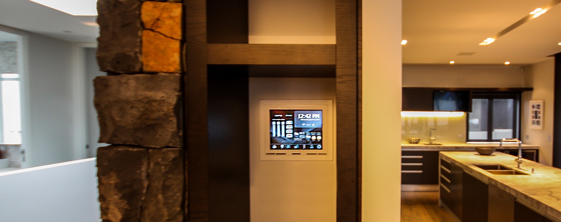 Discrete recessed touchscreen next to kitchen area for full home automation control