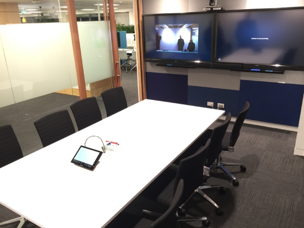 Meeting room at Fonterra with two 60" Screen TVs and touchscreen panel control