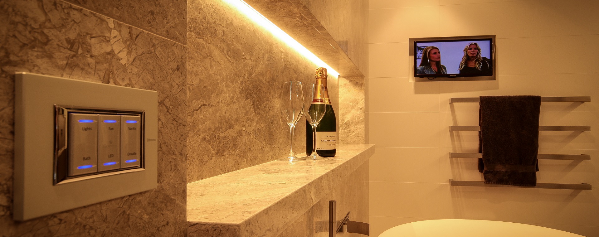 Beautiful bathroom with sleek keypad for control of lighting, TV and audio.