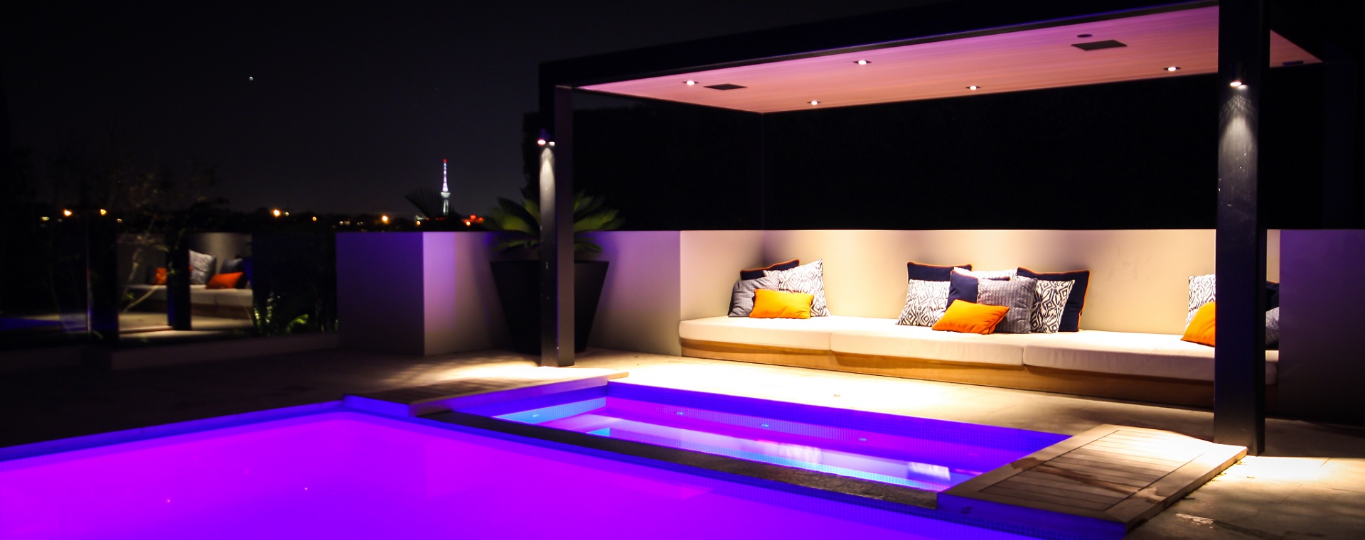 Pool cabana at night showing lighting control and in-ceiling speakers for enjoyment of music or moives