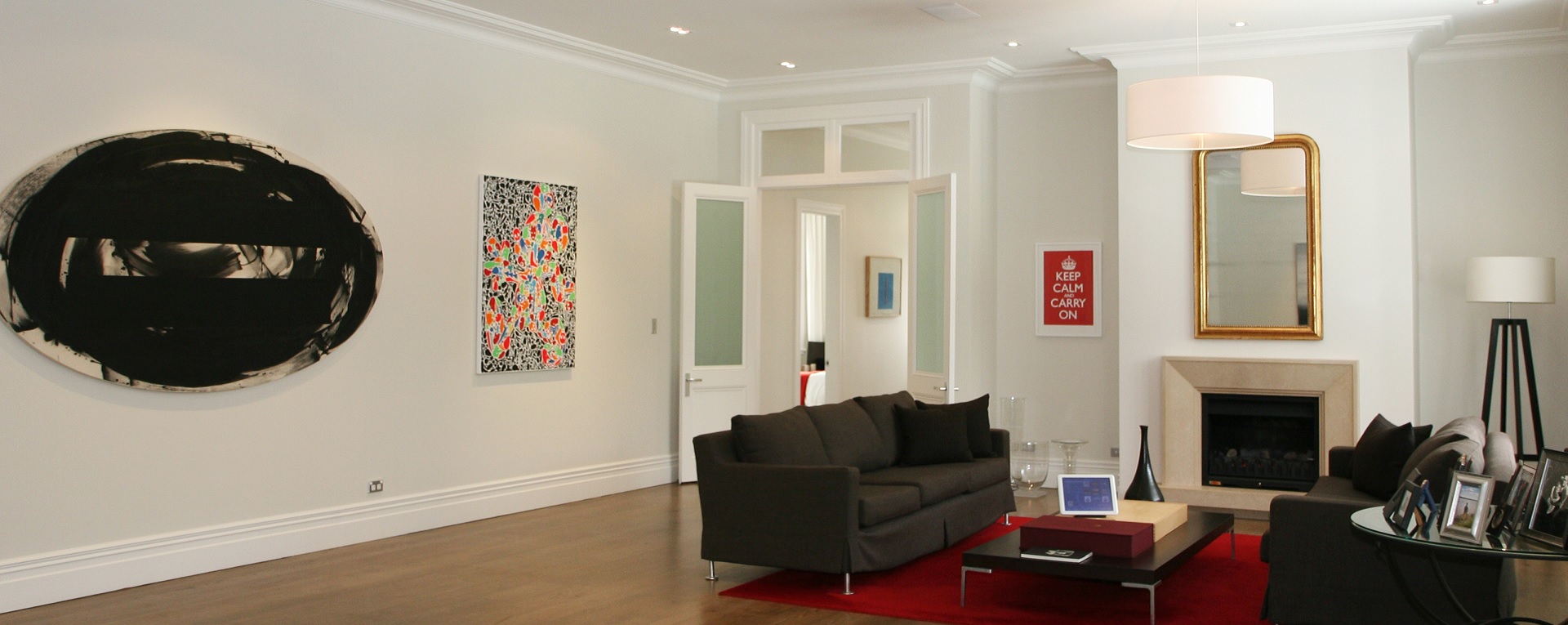Modern lounge with touchscreen control of home automation, in-ceiling speakers and discrete keypads for lighting control