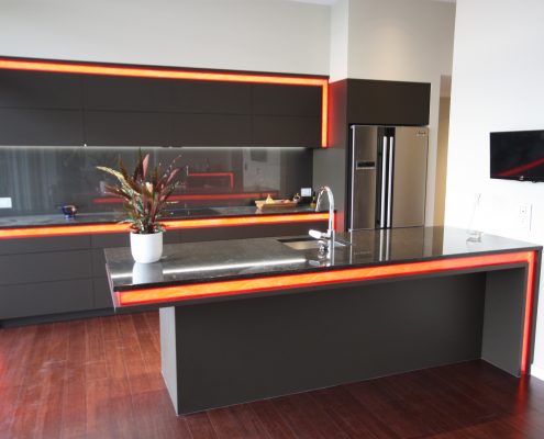 Kitchen with automated feature lighting and TV