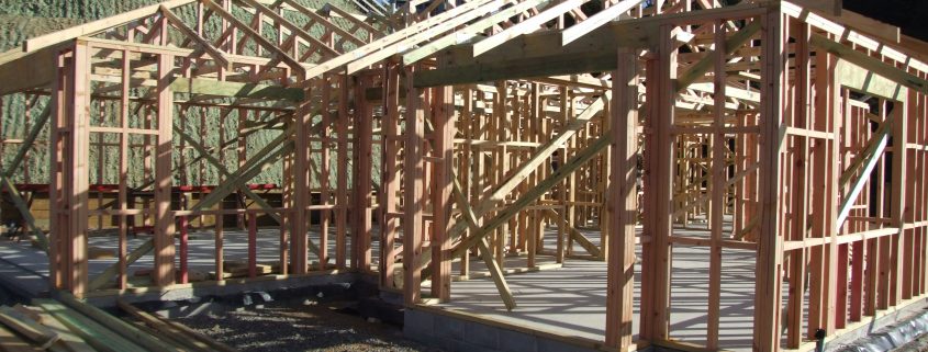 Building site showing a house in wooden framing stage