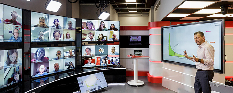 Man teaching a virtual classroom of students