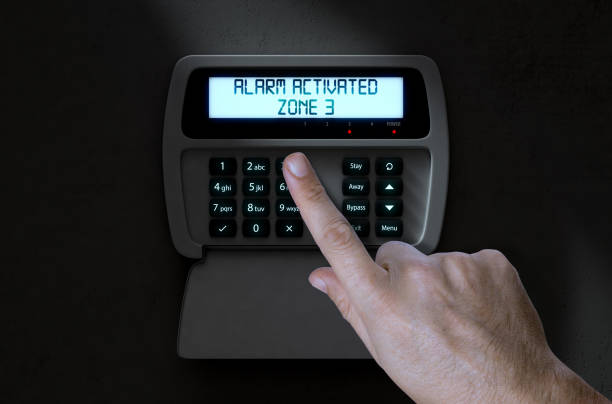 Person activating a home security panel by pressing button