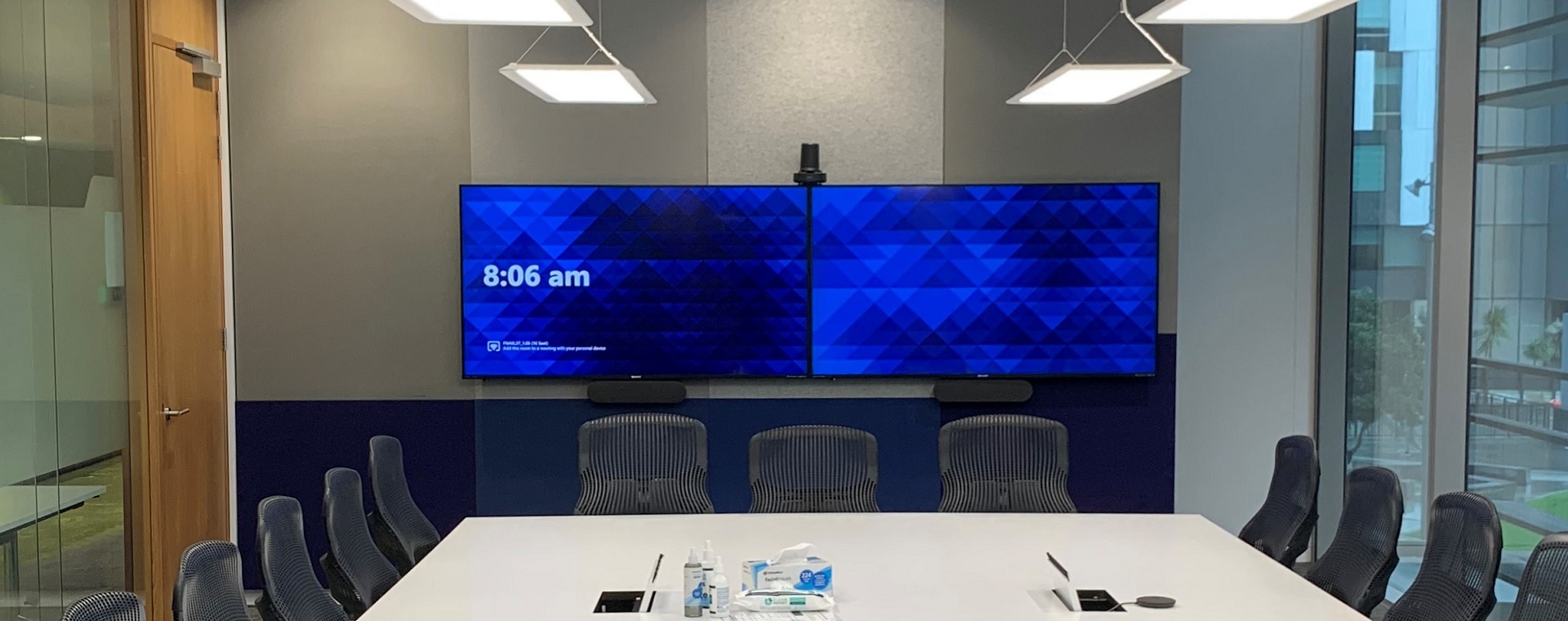 Fonterra meeting room with 2 large format display panels and connections for bring you own device