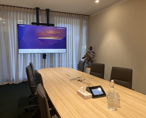 Generator Bowen Campus meeting room with large commercial display and table top control touchscreen