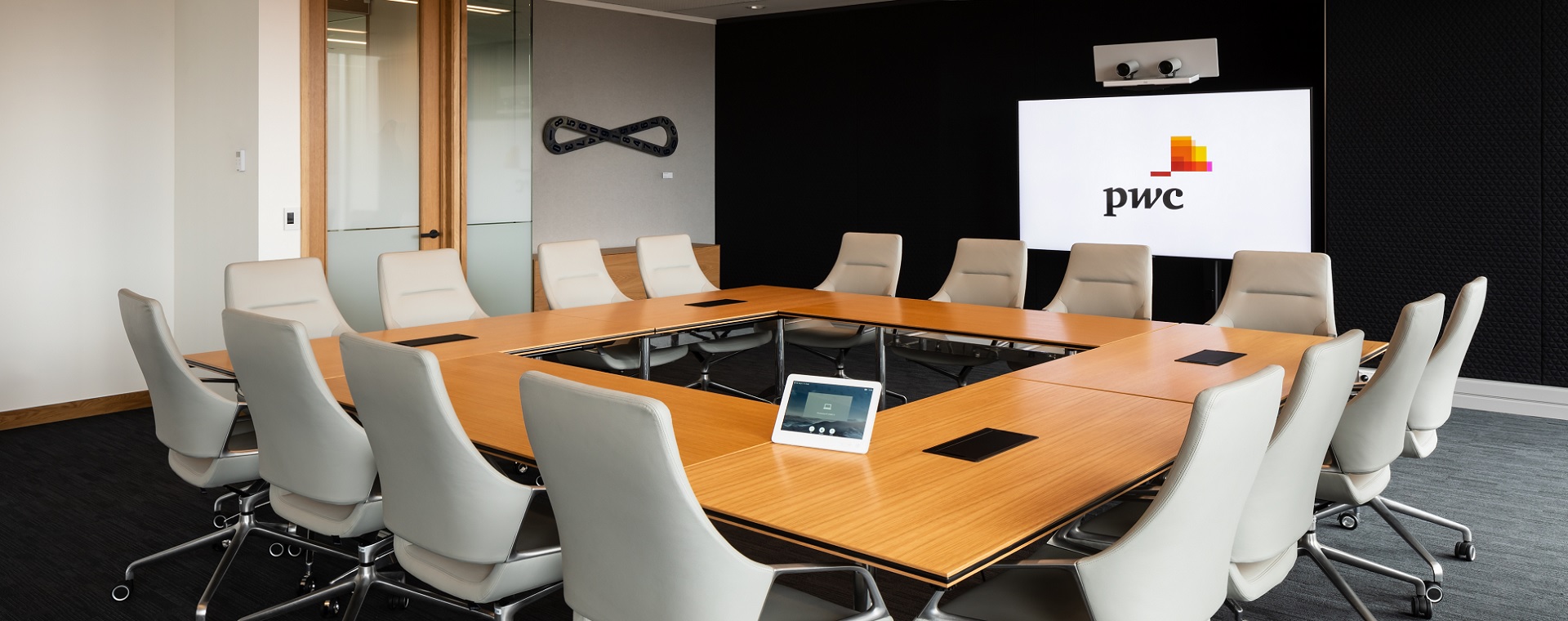 PwC meeting room with tablet control of AV systems, video conferencing system, audio and cameras