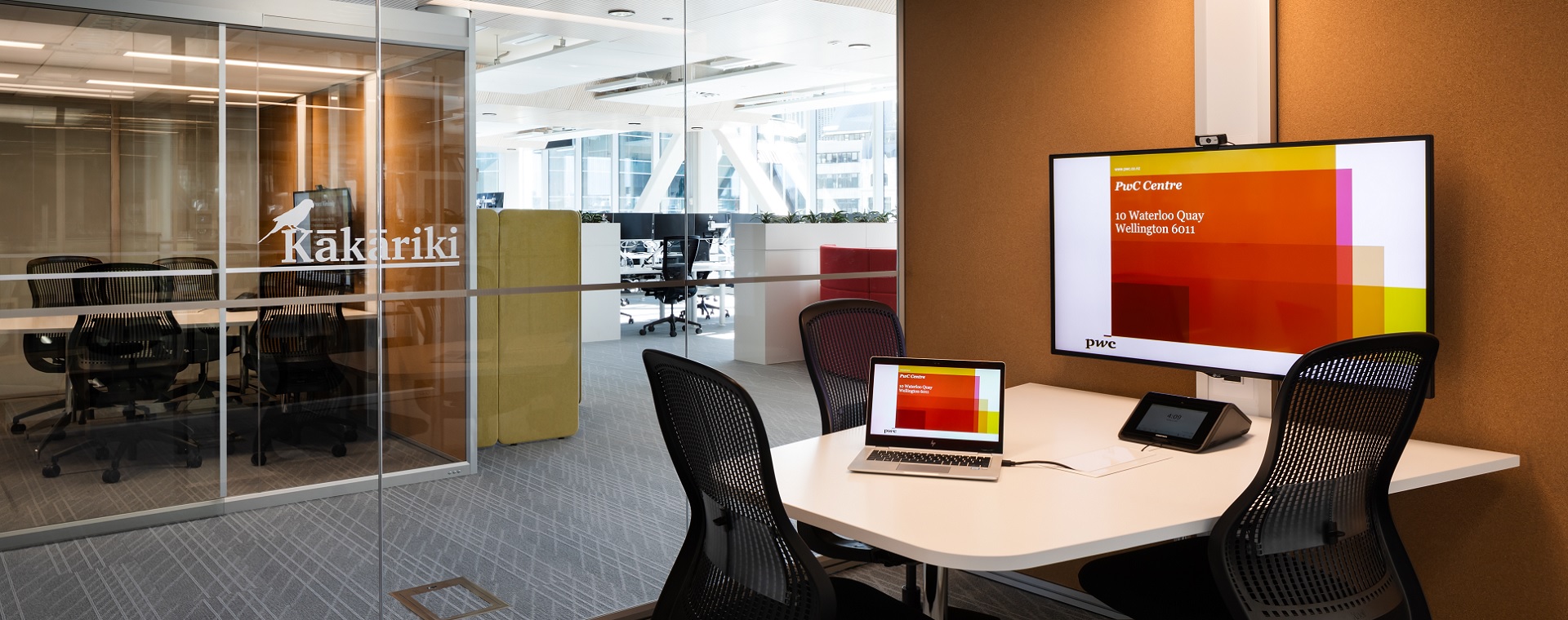 Small meeting room at PwC Wellington with tablet for AV control and video conferencing system.